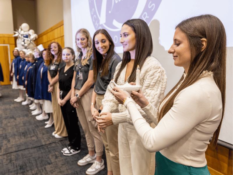 Nursing students joined members of the Mississippi Nurse Honor Guard for a ceremony passing a lamp, symbolizing the light of knowledge.